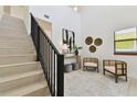 Elegant entryway with a staircase, contemporary decor, and plenty of natural light at 6315 S Richard Ave, Tampa, FL 33616
