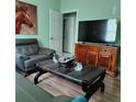 Inviting living room featuring a stylish leather chair, modern décor, and a large-screen TV at 6690 54Th N Ave, St Petersburg, FL 33709