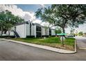 Exterior view of a two-story condominium complex surrounded by green spaces and mature trees at 801 Russell Ln # 255, Brandon, FL 33510