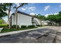 Exterior view of the two-story condominium with mature trees and well-maintained landscaping at 801 Russell Ln # 255, Brandon, FL 33510