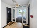 Interior hallway featuring tiled floors, apartment doors, exit sign and a welcome mat at 801 Russell Ln # 255, Brandon, FL 33510
