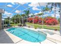 Screened-in pool features an attached spa and lush landscaping, creating a private outdoor oasis at 8902 30Th E St, Parrish, FL 34219