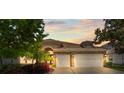 Charming home featuring stone accents, a tile roof, and a well-maintained two-car garage at 11534 Biddeford Pl, New Port Richey, FL 34654
