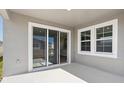Covered patio featuring sliding glass doors and ample space for outdoor seating at 12156 Cattleside Dr, Riverview, FL 33579