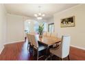 Elegant dining room with wood flooring, crown molding, a chandelier, and large wooden table at 12506 Safari Ln, Riverview, FL 33579