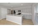 Modern kitchen with stainless steel appliances and a large center island at 13014 Wellspring Dr, Lithia, FL 33547