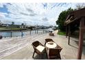A table with comfortable chairs on a patio overlooking a waterway, perfect for outdoor relaxation and dining at 13930 King Ave, Hudson, FL 34669