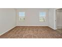Bright bedroom with large windows and plush carpeting, perfect for relaxation at 14773 Summer Branch Dr, Lithia, FL 33547