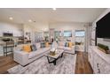 Spacious living room with hardwood floors, large windows, and stylish neutral furniture at 14781 Summer Branch Dr, Lithia, FL 33547
