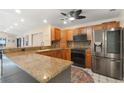 Well-equipped kitchen boasting wooden cabinets, stainless steel appliances, and a convenient breakfast bar at 1509 Coachlight Way, Dunedin, FL 34698
