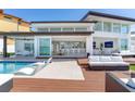 Backyard features an outdoor living space with a pool, deck, and water views at 16496 Redington Dr, Redington Beach, FL 33708