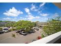 Exterior daytime view of the property showcasing lush trees, blue sky, and ample parking spaces at 2286 Norwegian Dr # 66, Clearwater, FL 33763
