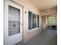 A charming entryway of a condo featuring a screen door and a cozy outdoor sitting area at 2286 Norwegian Dr # 66, Clearwater, FL 33763