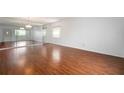Spacious living room with laminate flooring, a large mirror wall, and ample natural light at 2286 Norwegian Dr # 66, Clearwater, FL 33763