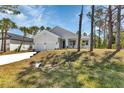 Charming one-story home boasts a manicured lawn, a two-car garage and a modern exterior at 2444 Jacobs St, Port Charlotte, FL 33953