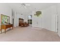 Open-concept living and dining area with neutral carpet, tall windows, and a chandelier for an inviting atmosphere at 3022 Forest Club Dr, Plant City, FL 33566