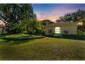 This home features mature trees, well-maintained landscaping, and a lush green lawn that enhances the beauty of its exterior at 3022 Forest Club Dr, Plant City, FL 33566