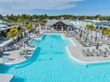 Resort-style pool with ample lounge chairs and umbrellas for relaxing by the water at 31649 Tansy Bnd, Wesley Chapel, FL 33545