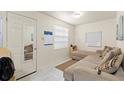 Bright living room with a comfortable sectional sofa and marble look floors at 3310 70Th N Ave, St Petersburg, FL 33702