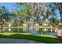 Scenic pond view showcasing lush greenery and an idyllic water feature in the community at 3380 Crystal Court E # G, Palm Harbor, FL 34685