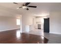 Open-concept living area with hardwood floors flowing into the kitchen and dining area, creating an inviting space at 5143 Jasmine Cir, St Petersburg, FL 33714