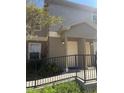 Welcoming condo exterior with neutral paint, welcoming front door and small decorative garden at 5904 Willow Ridge Dr # 202, Zephyrhills, FL 33541