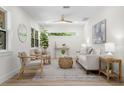 Bright living room features neutral decor, light wood flooring, and comfortable seating at 617 Scotland St, Dunedin, FL 34698