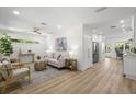 Bright, open living room features sleek hardwood floors, neutral décor, and modern furnishings at 617 Scotland St, Dunedin, FL 34698