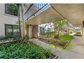 Lush courtyard walkway with beautiful landscaping leads to the front door, offering a serene approach to the residence at 6269 Palma Del Mar S Blvd # 112, St Petersburg, FL 33715
