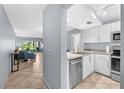 Efficient kitchen featuring stainless steel appliances and a convenient pass-through to the living area, perfect for modern living at 6269 Palma Del Mar S Blvd # 112, St Petersburg, FL 33715