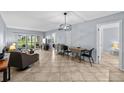 Bright living room with tile flooring, sliding glass doors and comfortable seating, providing a welcoming space to relax and entertain at 6269 Palma Del Mar S Blvd # 112, St Petersburg, FL 33715