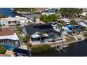 Aerial view featuring the home's screened pool, solar panels and dock on the water at 6505 Bimini Ct, Apollo Beach, FL 33572