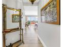 Long hallway with light hardwood floors leading to living and dining area with balcony access at 750 4Th Avenue South # 601H, St Petersburg, FL 33701