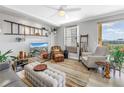 Cozy living room with ladder decor, a white ceiling fan, and comfortable leather armchairs at 750 4Th Avenue South # 601H, St Petersburg, FL 33701
