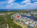 Aerial view of waterfront community featuring beautiful homes, boat docks and nearby ocean views at 814 Manns Harbor Dr, Apollo Beach, FL 33572