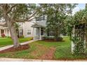 The two-story home boasts a charming front exterior, landscaped yard, and an inviting walkway at 9106 Crystal Commons Way, Tampa, FL 33626