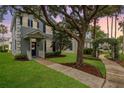 Charming two-story home with a landscaped yard and inviting walkway with a mature tree at 9106 Crystal Commons Way, Tampa, FL 33626