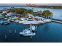 Stunning aerial view of waterfront home with private boat dock and pool overlooking the bay at 10 Brightwaters Ne Cir, St Petersburg, FL 33704
