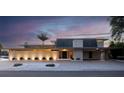 Modern home exterior with unique stone facade, walkway lighting and neutral colored driveway at 10 Brightwaters Ne Cir, St Petersburg, FL 33704