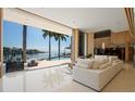Bright living room with an open floorplan and floor-to-ceiling sliding glass doors to the pool at 10 Brightwaters Ne Cir, St Petersburg, FL 33704