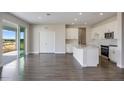 Open concept kitchen with white cabinets, a center island and stainless steel appliances at 10037 Surrey Rose Dr, San Antonio, FL 33576