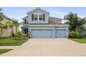 Charming two-story home features a well-manicured lawn and a spacious two-car garage at 11911 Greenchop Pl, Riverview, FL 33579