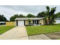 Charming single Gathering home with lush landscaping and attached garage and long driveway at 11928 Mandarin Ct, Seminole, FL 33772