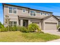 Beautiful two-story home featuring lush landscaping, multiple windows and a three car garage at 12107 Nouveau Ave, Spring Hill, FL 34610
