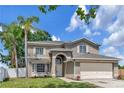 Charming two-story home boasts an attached two-car garage and a lush front lawn at 12653 Longcrest Dr, Riverview, FL 33579
