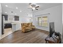 Open-concept living room with modern flooring and natural light, seamlessly connected to the kitchen at 14434 Scottburgh Glen Dr, Wimauma, FL 33598