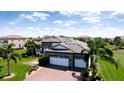 An aerial view of the home showing an expansive brick driveway and three-car garage at 16612 5Th E Ave, Bradenton, FL 34212