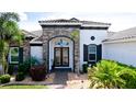 Charming front entrance features brick accents and detailed door at 16612 5Th E Ave, Bradenton, FL 34212