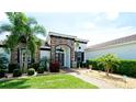 Beautiful home exterior featuring a well-manicured lawn, lush landscaping, and a striking stone facade at 16612 5Th E Ave, Bradenton, FL 34212