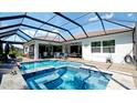 A view of the crystal-clear blue pool and spa with screened enclosure at 16612 5Th E Ave, Bradenton, FL 34212